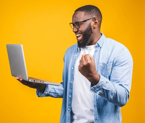 man celebrating saved revenue from automated member win-back campaign