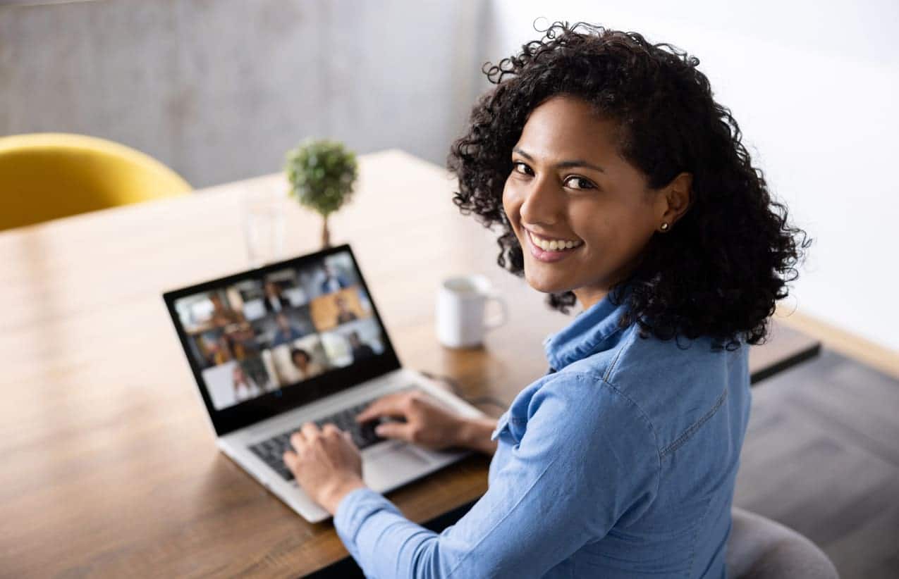 woman attending virtual event on laptop