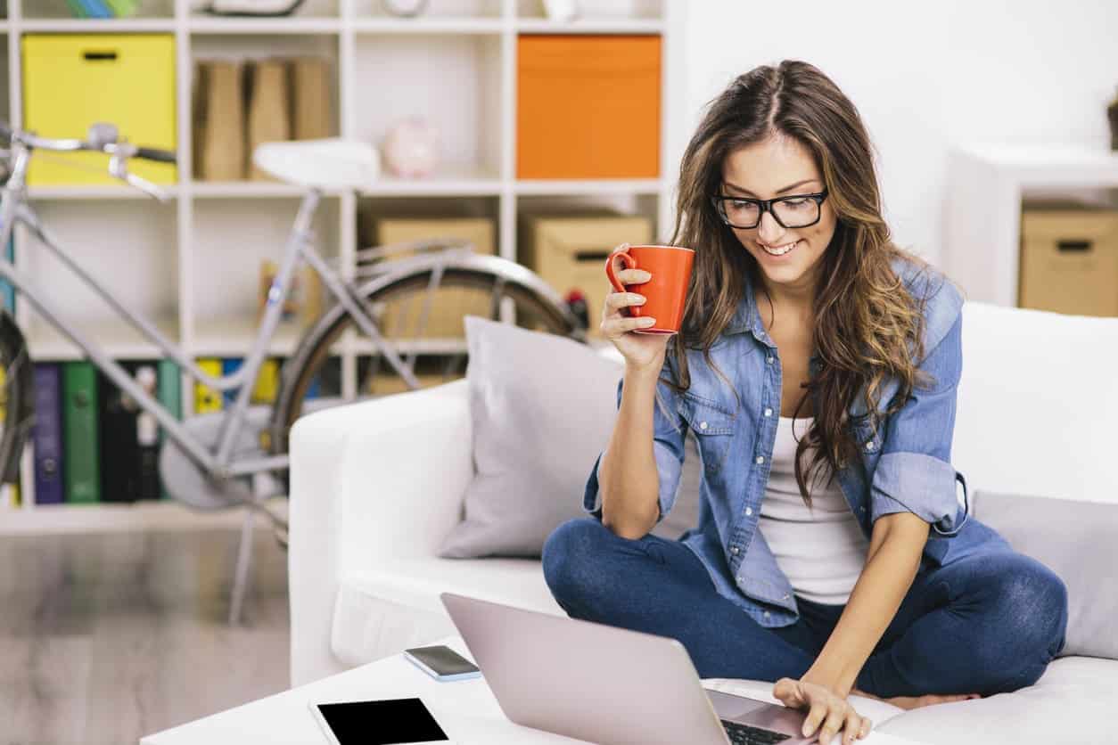 woman on computer drinking coffee