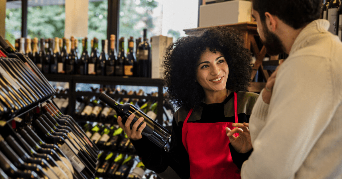 Wine merchant selling wine to a repeat customer