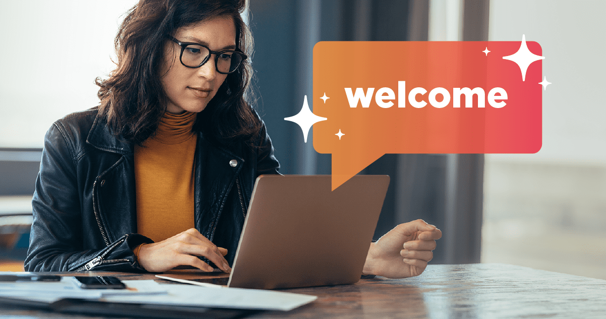 Woman looking at computer with "welcome" speech bubble