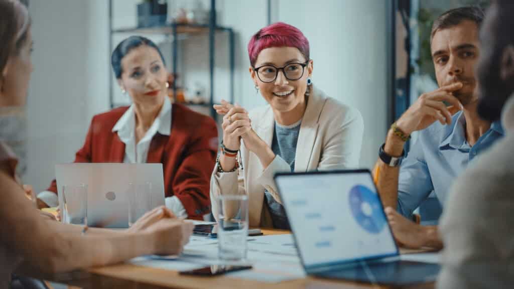 person with pink hair in advocacy planning meeting