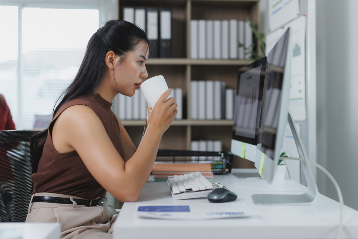 association professional sitting down with a coffee to look through association email benchmarks