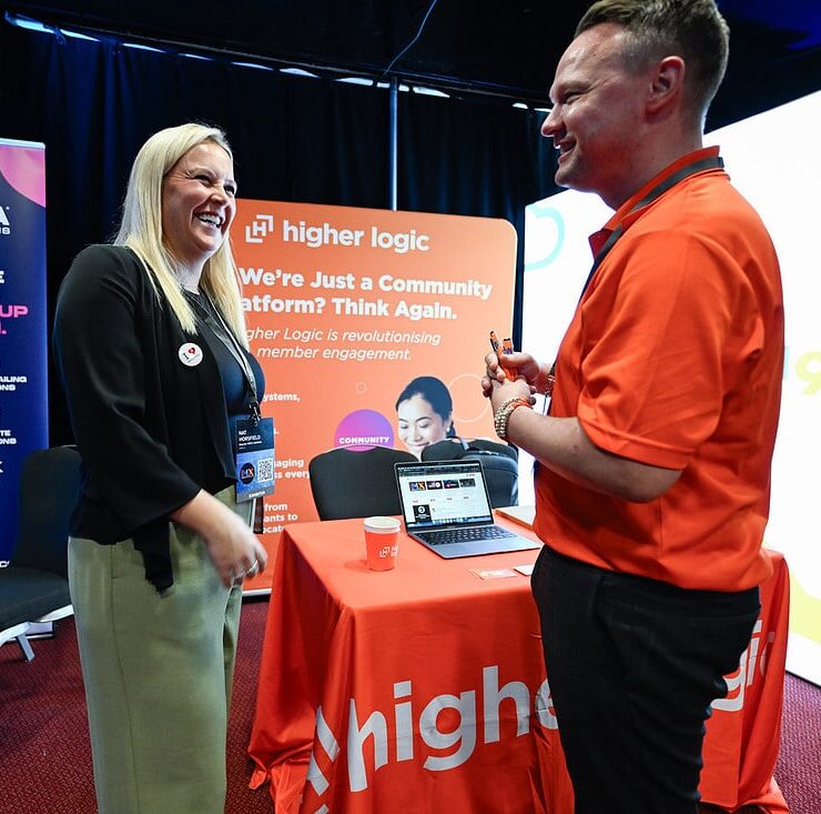 MemberWise staff chatting with Higher Logic at an event, choosing a community vendor