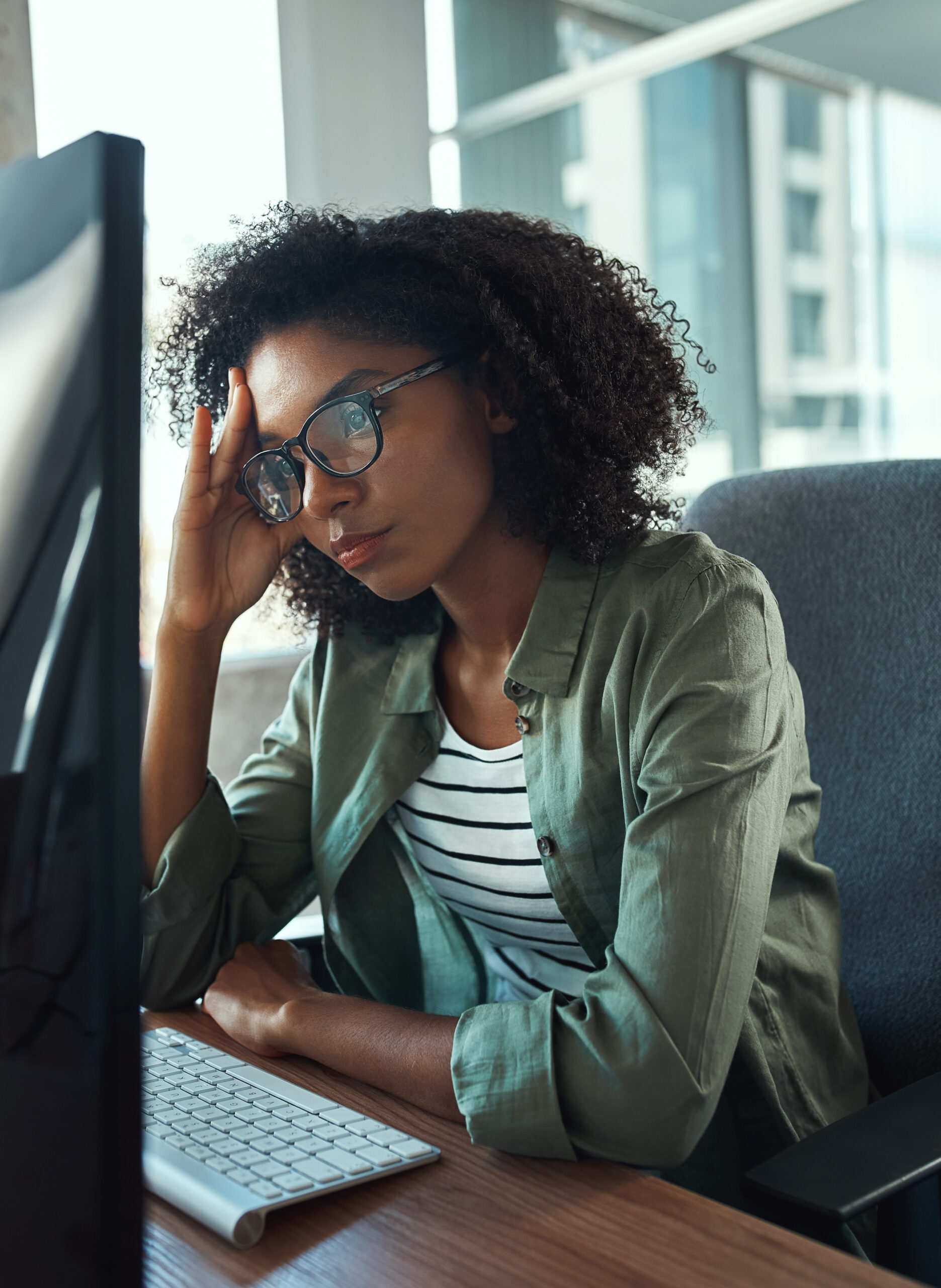 woman frowning at computer, stressed about getting board approval for community software