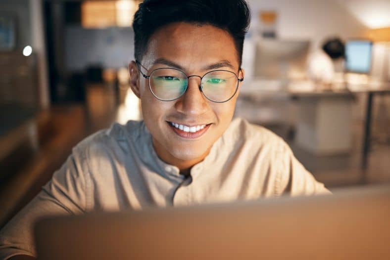 Community manager for customer support community moderating via laptop