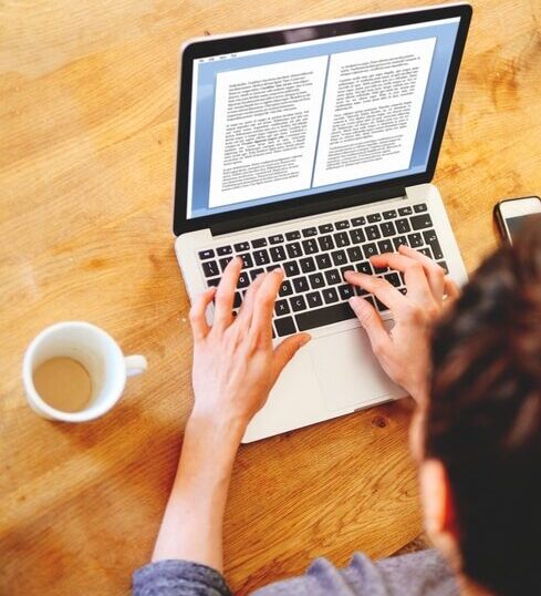 person working on writing content on laptop and using clear structure for AI discoverability